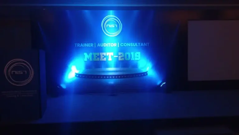 MEET 2019 stage lit in blue with a projected logo