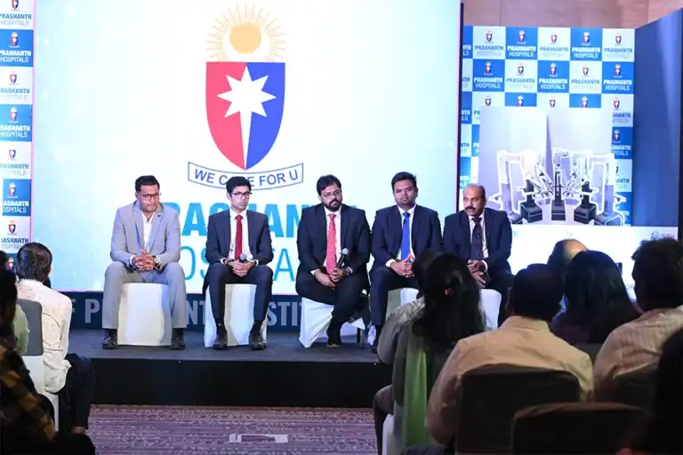 Hospital leadership seated on stage for a panel