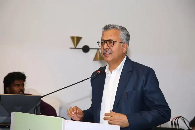 Speaker at a lectern addressing a conference audience