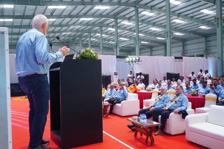 Speaker at a lectern addressing guests at the Stulz Chennai factory inauguration