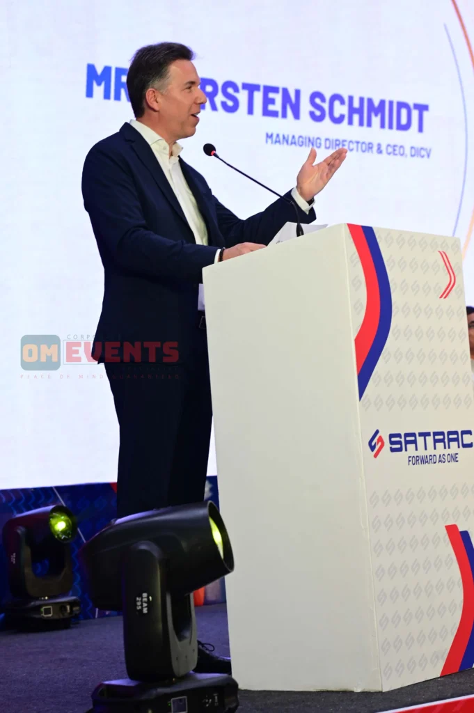 Visiting German dignitary addressing guests from a Satrac lectern