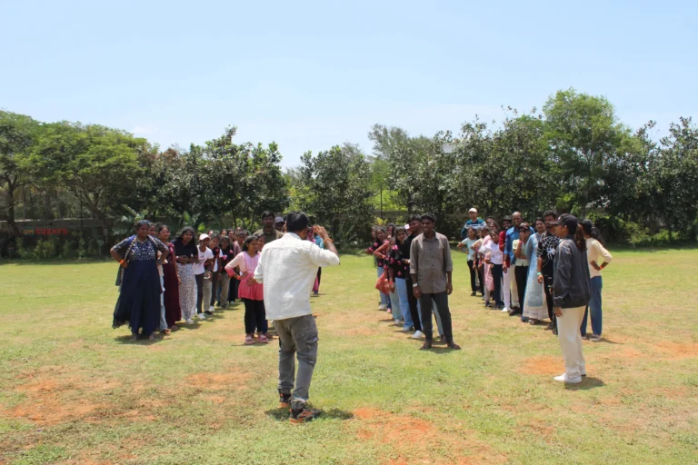 Team activity in a circle on a resort lawn
