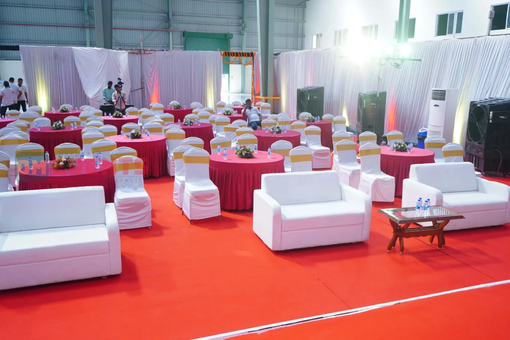 VIP lounge with white sofas and red carpet set for the guests of honour