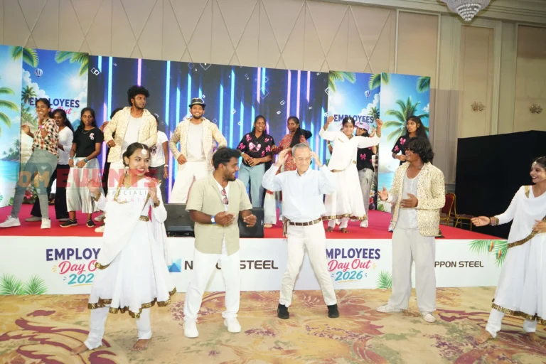 Visiting leaders dancing with employees on stage